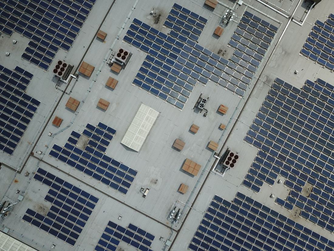 Aerial view of solar arrays on a commercial rooftop
